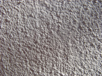detail of a rendered wall in sunlight and shadow